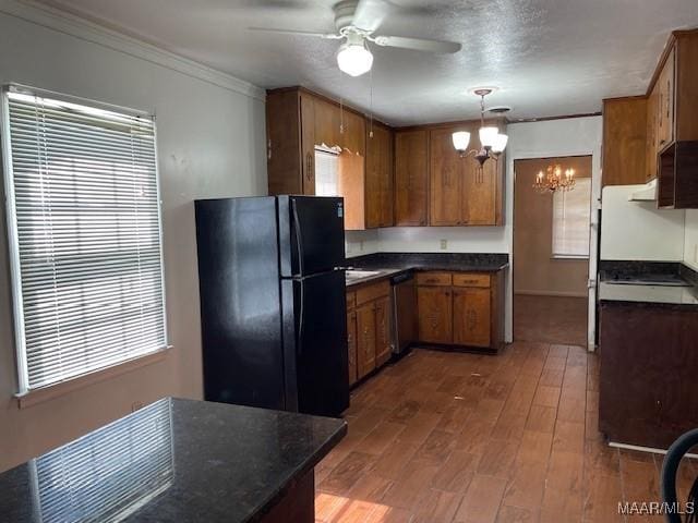 2300 Wentworth Dr, Montgomery, AL 36106 - kitchen featuring freestanding refrigerator, dark countertops, a chandelier, crown molding, and brown cabinetry