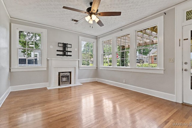 102 Vonora Ave, Montgomery, AL 36107 - unfurnished living room featuring plenty of natural light, light wood finished floors, a fireplace, and crown molding