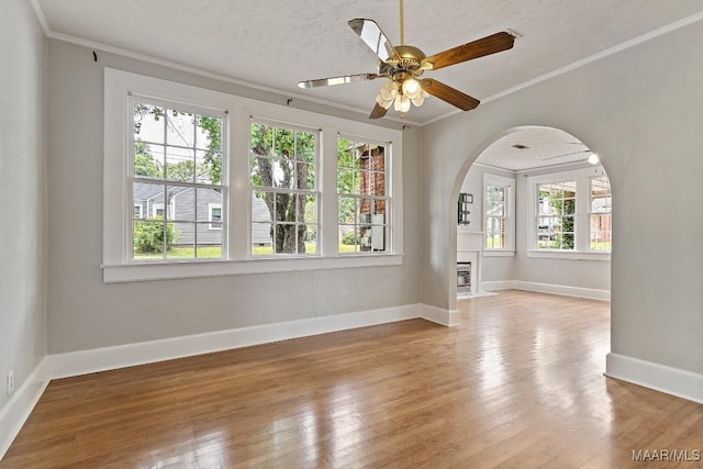 102 Vonora Ave, Montgomery, AL 36107 - spare room with arched walkways, healthy amount of natural light, ornamental molding, wood finished floors, and a ceiling fan
