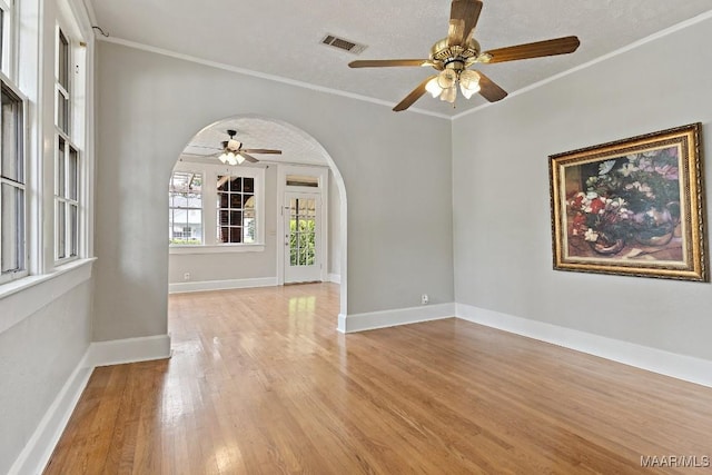 102 Vonora Ave, Montgomery, AL 36107 - empty room featuring arched walkways, a ceiling fan, light wood finished floors, and crown molding