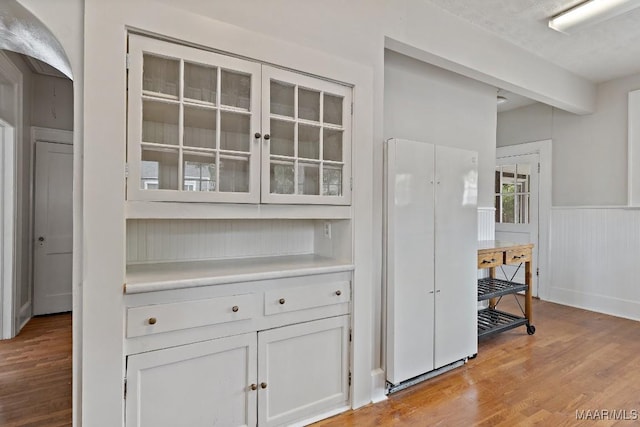 102 Vonora Ave, Montgomery, AL 36107 - bar with light wood-type flooring and wainscoting