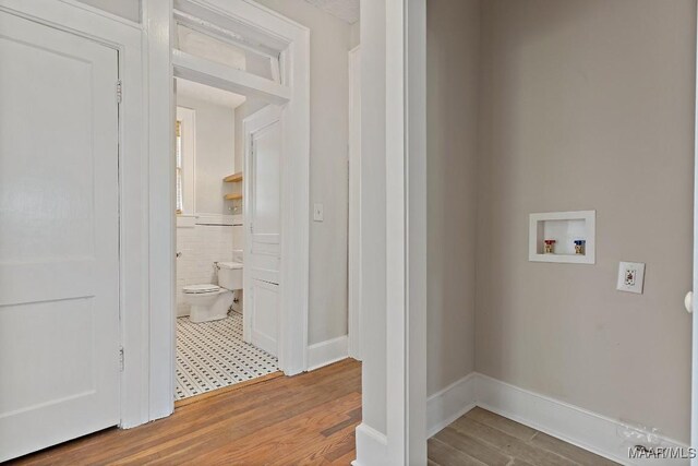 102 Vonora Ave, Montgomery, AL 36107 - laundry area featuring washer hookup, wainscoting, wood finished floors, and tile walls