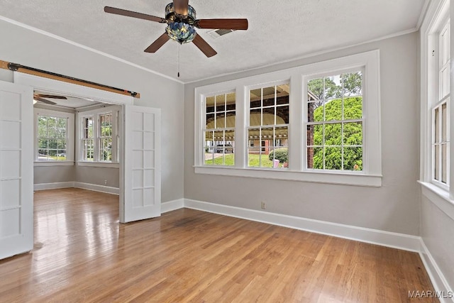102 Vonora Ave, Montgomery, AL 36107 - spare room with ceiling fan, healthy amount of natural light, light wood-style floors, a textured ceiling, and crown molding