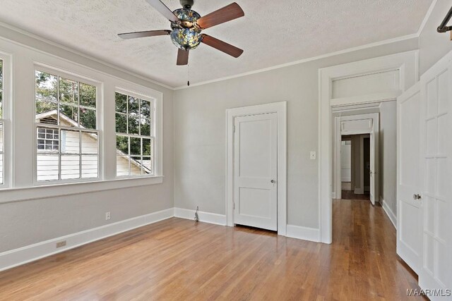 102 Vonora Ave, Montgomery, AL 36107 - unfurnished bedroom with a textured ceiling, wood finished floors, ornamental molding, and ceiling fan