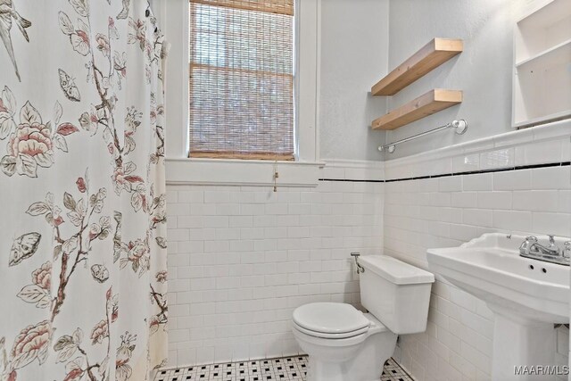 102 Vonora Ave, Montgomery, AL 36107 - full bathroom with tile walls, a shower with curtain, and wainscoting