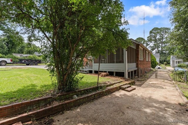 102 Vonora Ave, Montgomery, AL 36107 - view of property exterior featuring a gate, a yard, and a sunroom