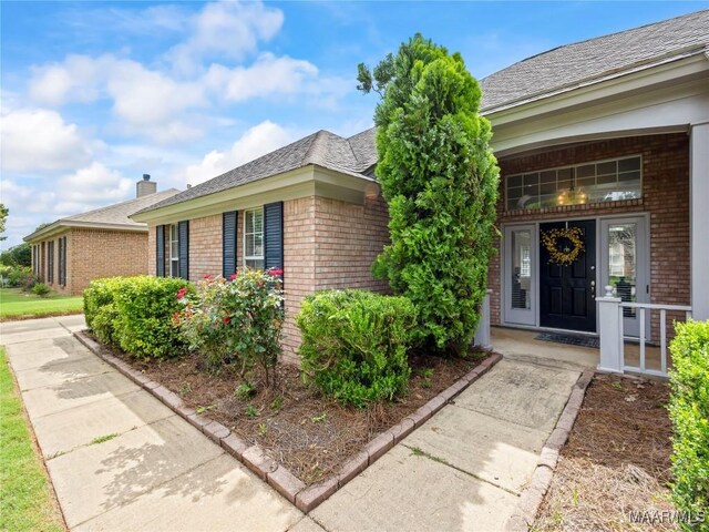 7117 Stamford Ct, Montgomery, AL 36117 - property entrance featuring brick siding, covered porch, and a chimney