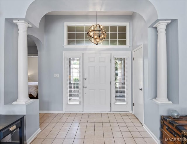 7117 Stamford Ct, Montgomery, AL 36117 - foyer entrance featuring ornate columns, light tile patterned floors, arched walkways, and a chandelier