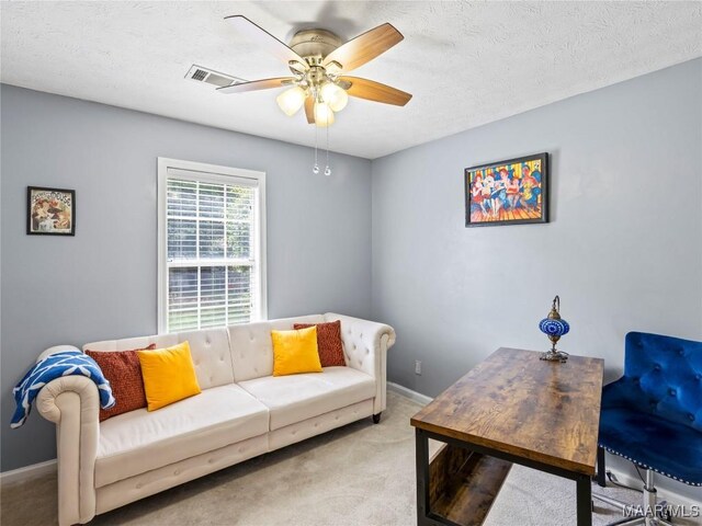 7117 Stamford Ct, Montgomery, AL 36117 - carpeted living room featuring a ceiling fan and a textured ceiling