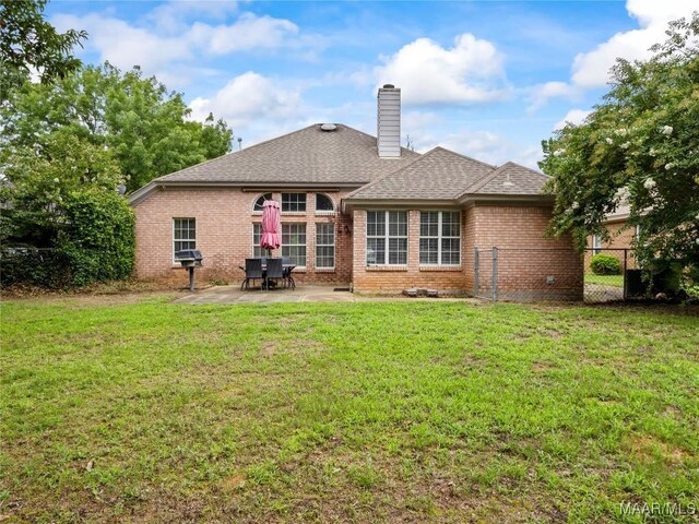 7117 Stamford Ct, Montgomery, AL 36117 - back of house with brick siding, a patio area, a shingled roof, and a chimney