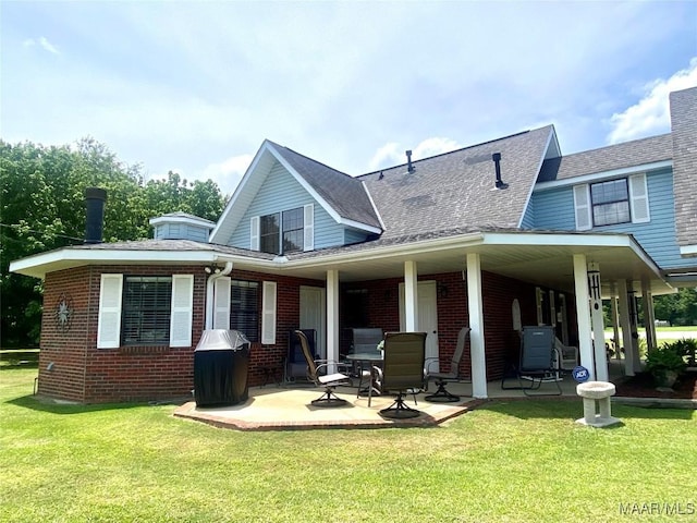 5240 Airport Rd, Millbrook, AL 36054 - rear view of property with a yard, brick siding, and roof with shingles