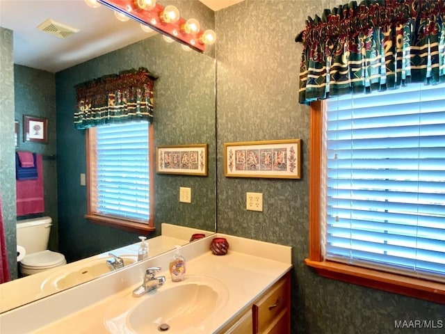 5240 Airport Rd, Millbrook, AL 36054 - bathroom featuring vanity, plenty of natural light, and wallpapered walls
