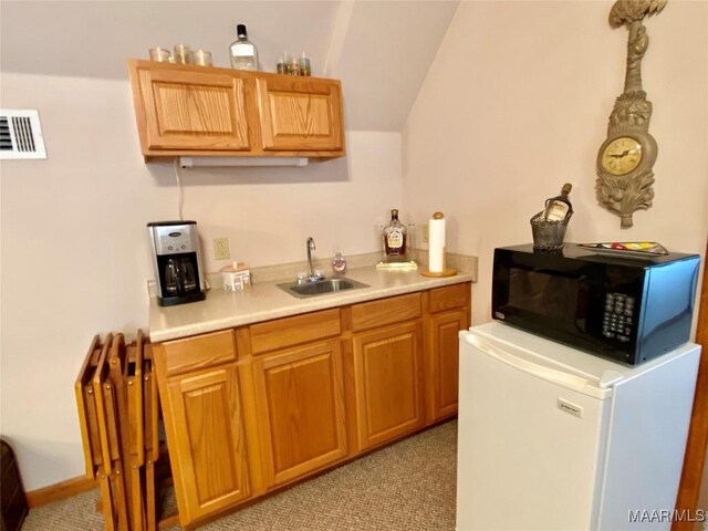 5240 Airport Rd, Millbrook, AL 36054 - indoor wet bar featuring fridge, black microwave, vaulted ceiling, and light colored carpet