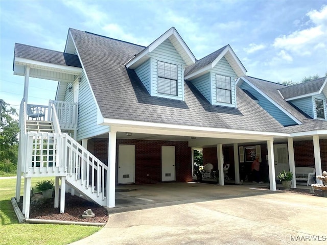 5240 Airport Rd, Millbrook, AL 36054 - view of front of house with driveway, brick siding, a carport, and roof with shingles
