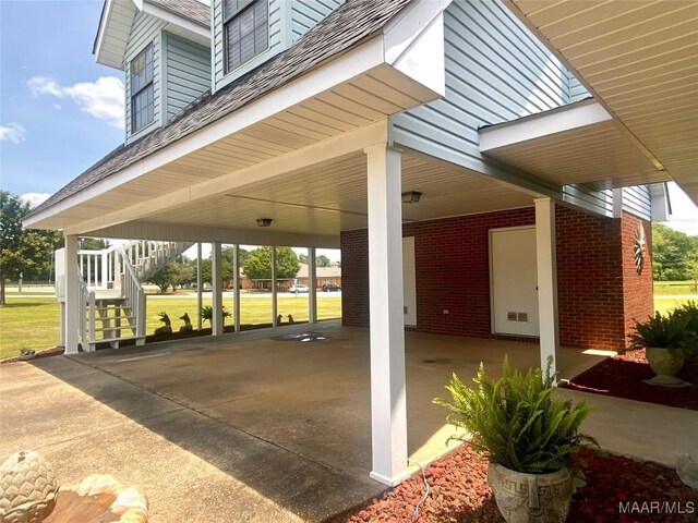 5240 Airport Rd, Millbrook, AL 36054 - view of patio with stairway and a carport