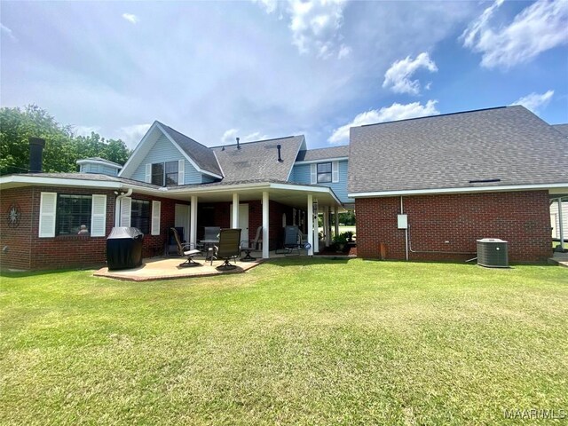 5240 Airport Rd, Millbrook, AL 36054 - rear view of property with brick siding, a lawn, and a patio