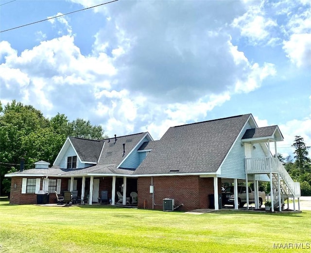 5240 Airport Rd, Millbrook, AL 36054 - view of front of house featuring brick siding, a front yard, a porch, and roof with shingles