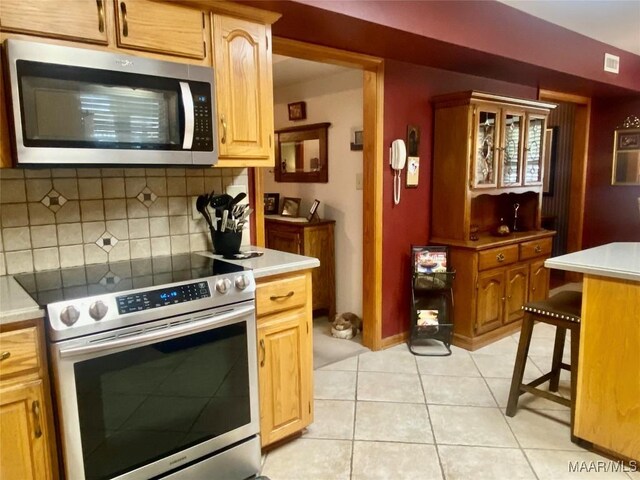 5240 Airport Rd, Millbrook, AL 36054 - kitchen with stainless steel appliances, light countertops, and backsplash