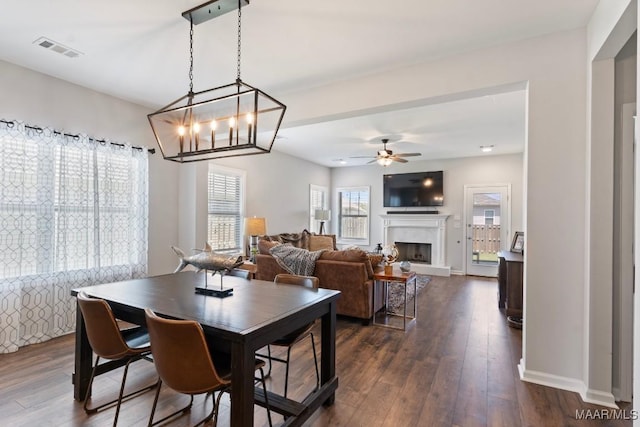 904 Hedgefield Way, Prattville, AL 36066 - dining area featuring ceiling fan, dark wood finished floors, and a fireplace with raised hearth