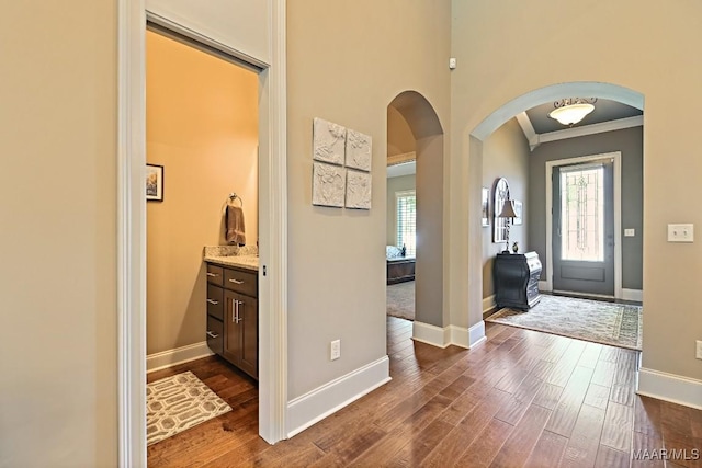 8612 Birchwood Ct, Montgomery, AL 36116 - entrance foyer featuring arched walkways, crown molding, and dark wood-style flooring