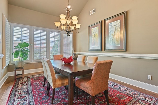 8612 Birchwood Ct, Montgomery, AL 36116 - dining room featuring wood finished floors, a chandelier, and vaulted ceiling