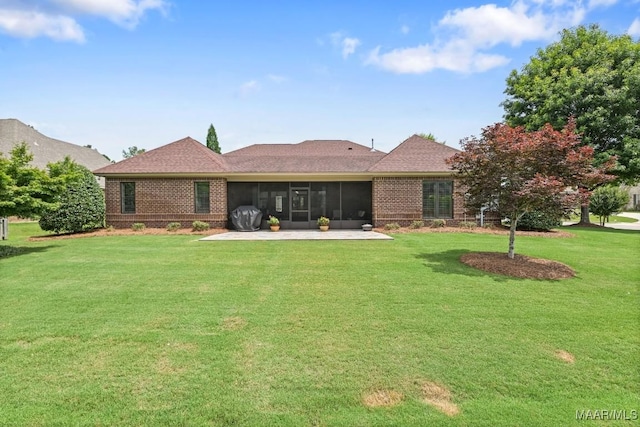 8612 Birchwood Ct, Montgomery, AL 36116 - back of house featuring a sunroom, brick siding, and a lawn