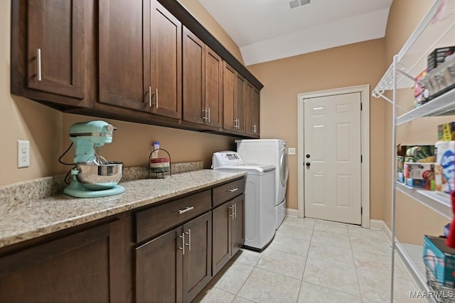 8612 Birchwood Ct, Montgomery, AL 36116 - washroom featuring cabinet space, washer and clothes dryer, and light tile patterned floors