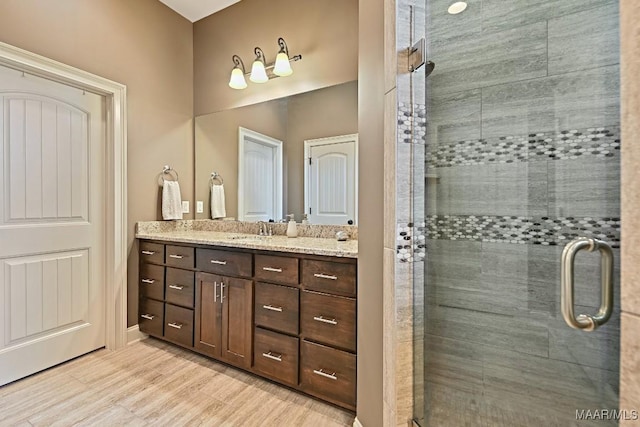 8612 Birchwood Ct, Montgomery, AL 36116 - full bathroom featuring vanity, a shower stall, and wood finished floors