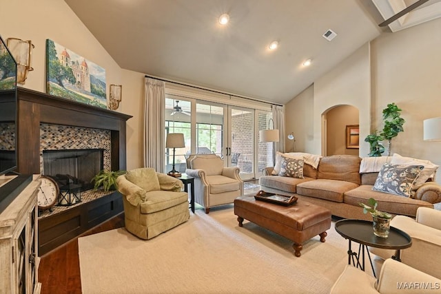 8612 Birchwood Ct, Montgomery, AL 36116 - living room with arched walkways, wood finished floors, a tile fireplace, high vaulted ceiling, and recessed lighting