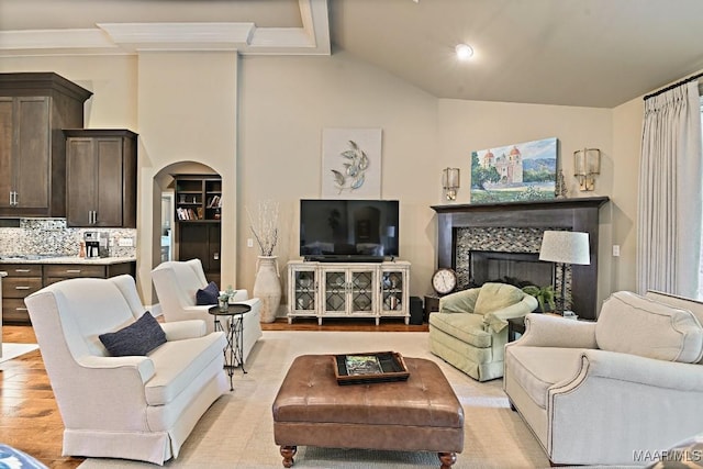 8612 Birchwood Ct, Montgomery, AL 36116 - living room featuring arched walkways, a fireplace, light wood-style flooring, and lofted ceiling