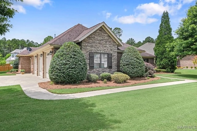 8612 Birchwood Ct, Montgomery, AL 36116 - view of property exterior with an attached garage, a lawn, stone siding, and driveway