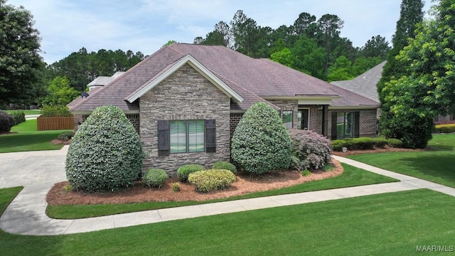 8612 Birchwood Ct, Montgomery, AL 36116 - view of front of home with stone siding, a front yard, and roof with shingles