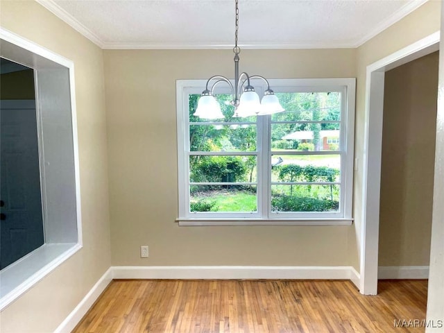 2441 Spruce Curv, Montgomery, AL 36107 - unfurnished dining area featuring healthy amount of natural light, wood finished floors, a chandelier, and crown molding