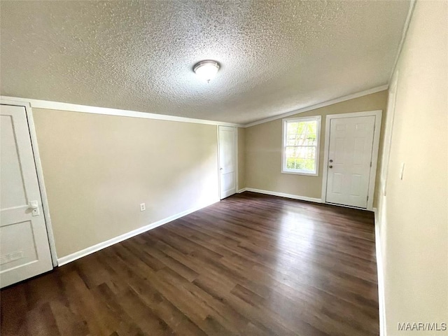 2441 Spruce Curv, Montgomery, AL 36107 - spare room featuring lofted ceiling, a textured ceiling, and dark wood-style flooring