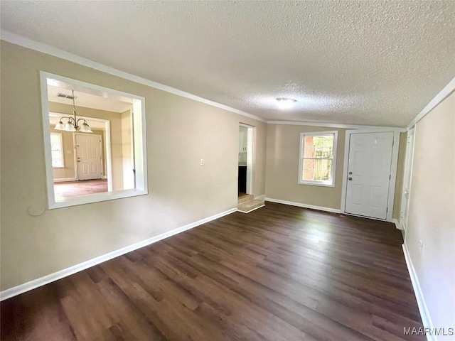 2441 Spruce Curv, Montgomery, AL 36107 - spare room with a textured ceiling, dark wood-style floors, a chandelier, and ornamental molding