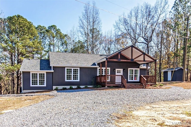 11056 Central Plank Rd, Eclectic, AL 36024 - view of front of house featuring a shingled roof, a deck, a shed, and driveway