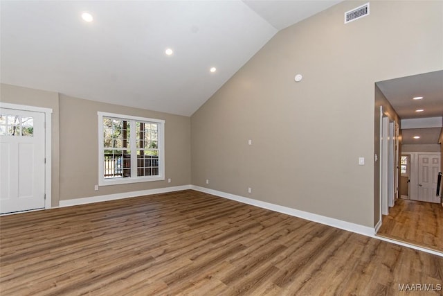 11056 Central Plank Rd, Eclectic, AL 36024 - unfurnished living room featuring wood finished floors, vaulted ceiling, and recessed lighting