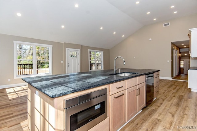 11056 Central Plank Rd, Eclectic, AL 36024 - kitchen with light wood-type flooring, recessed lighting, lofted ceiling, a kitchen island with sink, and dark countertops