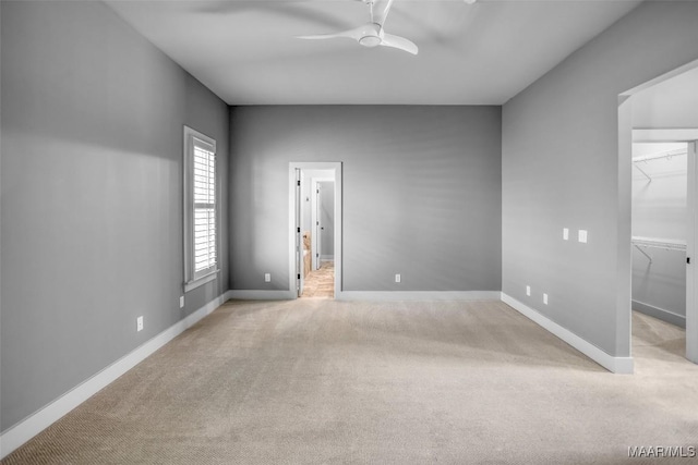 7918 Long Acre St, Montgomery, AL 36116 - unfurnished bedroom with light colored carpet, a walk in closet, a ceiling fan, and a closet