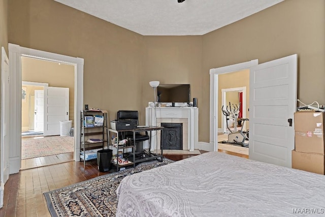1802 Madison Ave, Montgomery, AL 36107 - bedroom with hardwood / wood-style flooring and a tiled fireplace