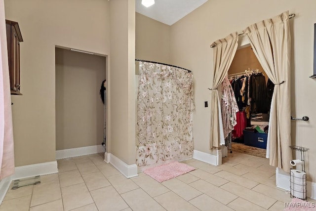 1802 Madison Ave, Montgomery, AL 36107 - full bath featuring tile patterned flooring, curtained shower, and a spacious closet