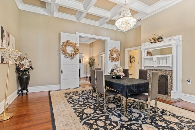 1802 Madison Ave, Montgomery, AL 36107 - dining area featuring a premium fireplace, a chandelier, wood finished floors, coffered ceiling, and beamed ceiling