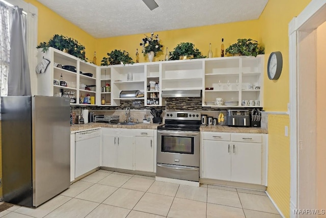 1802 Madison Ave, Montgomery, AL 36107 - kitchen featuring stainless steel appliances, open shelves, wall chimney range hood, white cabinets, and a textured ceiling