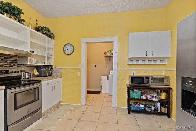 1802 Madison Ave, Montgomery, AL 36107 - kitchen with stainless steel appliances, wall chimney exhaust hood, white cabinets, open shelves, and light countertops