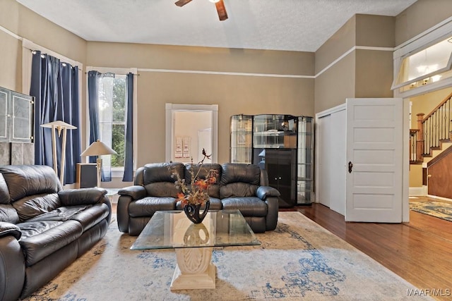1802 Madison Ave, Montgomery, AL 36107 - living room featuring wood finished floors, a ceiling fan, and stairs