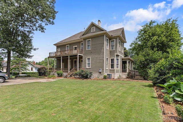 1802 Madison Ave, Montgomery, AL 36107 - view of front of home featuring a front yard, a chimney, and a balcony