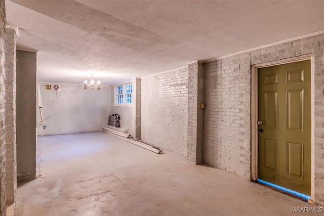 3534 Milan Dr, Montgomery, AL 36109 - basement with a chandelier and brick wall