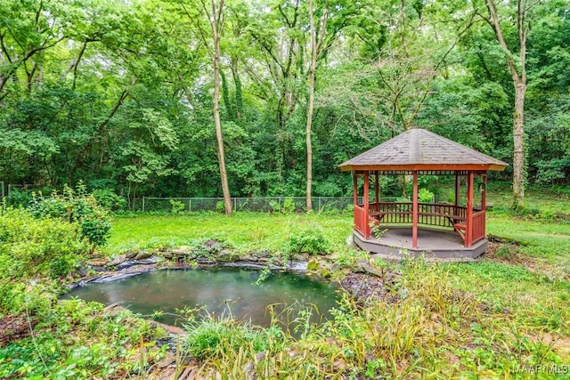 3534 Milan Dr, Montgomery, AL 36109 - view of yard featuring a gazebo, a view of trees, and a garden pond