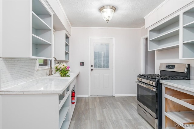 3534 Milan Dr, Montgomery, AL 36109 - kitchen featuring open shelves, gas range, a textured ceiling, light wood finished floors, and backsplash