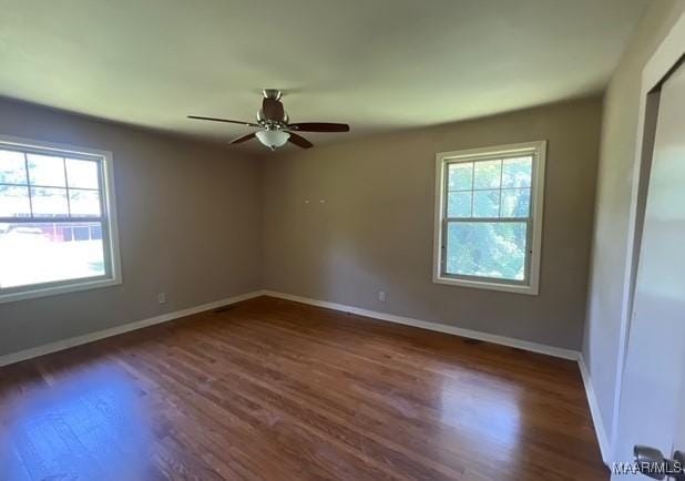323 E Highland St, Dadeville, AL 36853 - empty room with healthy amount of natural light, wood finished floors, and a ceiling fan